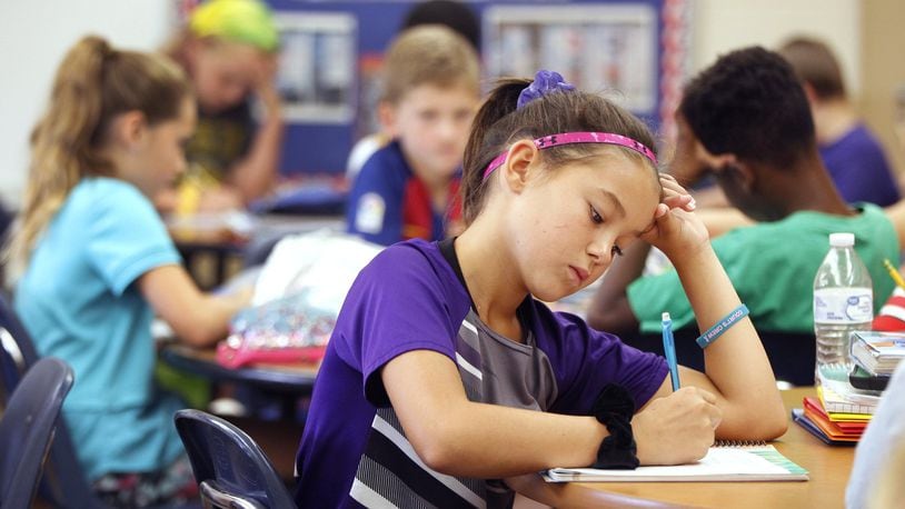 McKenna Myer, a fourth grade student at Northmoor Elementary School in Englewood, writes in a journal during class. The practice is an effort to address social-emotional skills. LISA POWELL / STAFF