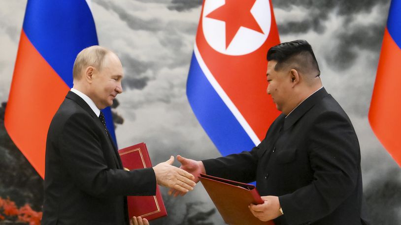 Russian President Vladimir Putin, left, and North Korea's leader Kim Jong Un exchange documents during a signing ceremony of the new partnership in Pyongyang, North Korea, on Wednesday, June 19, 2024. Putin and Kim signed a new partnership that includes a vow of mutual aid if either country is attacked, during a Wednesday summit that came as both face escalating standoffs with the West. (Kristina Kormilitsyna, Sputnik, Kremlin Pool Photo via AP)
