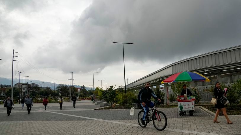 People walk outside of a metro station after a nationwide blackout, in Quito, Ecuador, Wednesday, June 19, 2024. (AP Photo/Dolores Ochoa)