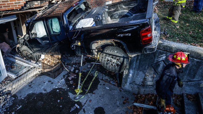 A pickup truck crashed into an apartment building at Wayne and Wilmington avenues Thursday, Oct. 27, 2022, in Dayton, injuring two people sitting on a couch in an apartment and two people in the truck. JIM NOELKER/STAFF