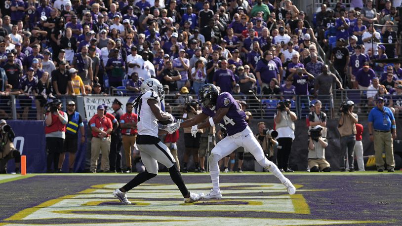 Las Vegas Raiders wide receiver Davante Adams, left, catches a touchdown pass against Baltimore Ravens cornerback Marlon Humphrey (44) during the second half of an NFL football game, Sunday, Sept. 15, 2024, in Baltimore. (AP Photo/Stephanie Scarbrough)