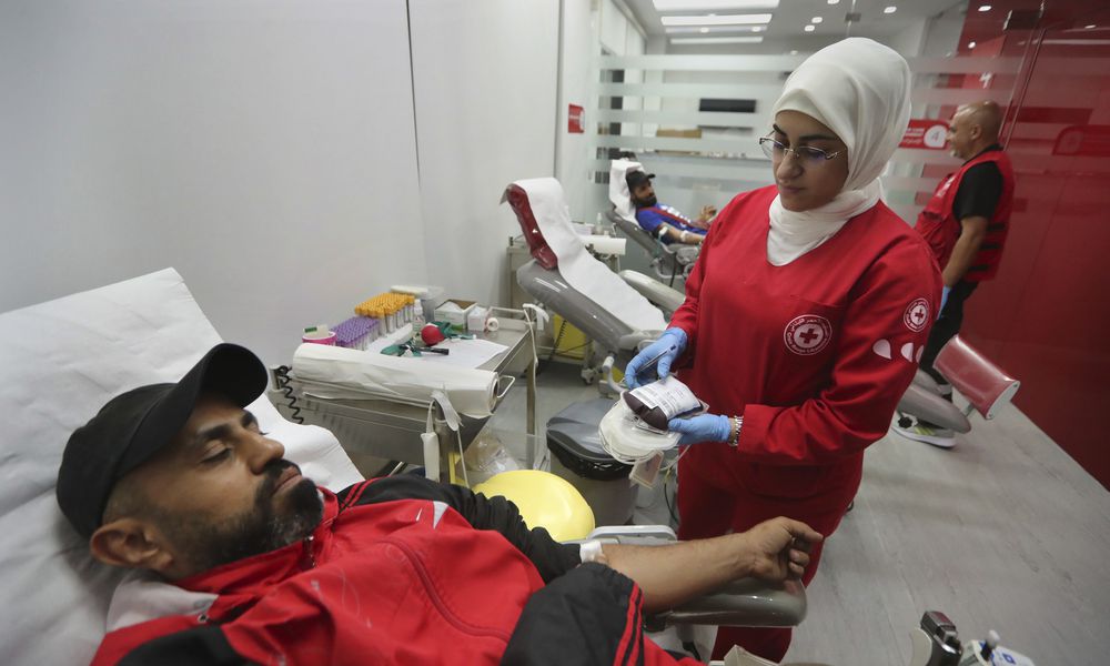 People donate blood for those who were injured by their exploded handheld pagers, at a Red Cross center, in the southern port city of Sidon, Lebanon, Tuesday, Sept. 17, 2024. (AP Photo/Mohammed Zaatari)