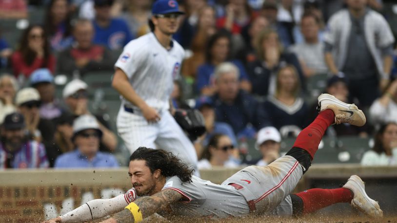 Cincinnati Reds' Jonathan India slides safely into home plate on a Elly De La Cruz 2 RBI double during the tenth inning of a baseball game against the Chicago Cubs in Chicago, Sunday, Sept. 29, 2024. (AP Photo/Paul Beaty)