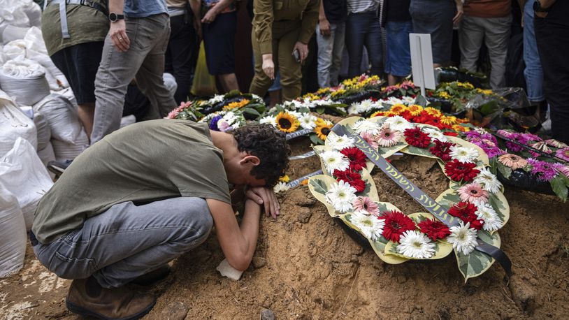 Mourners at the funeral of Col. Roi Levy, an Israeli soldier killed when Palestinian militants infiltrated Israel, in the Mount Herzl military cemetery in Jerusalem, Monday, Oct. 9, 2023. (Tamir Kalifa/The New York Times)