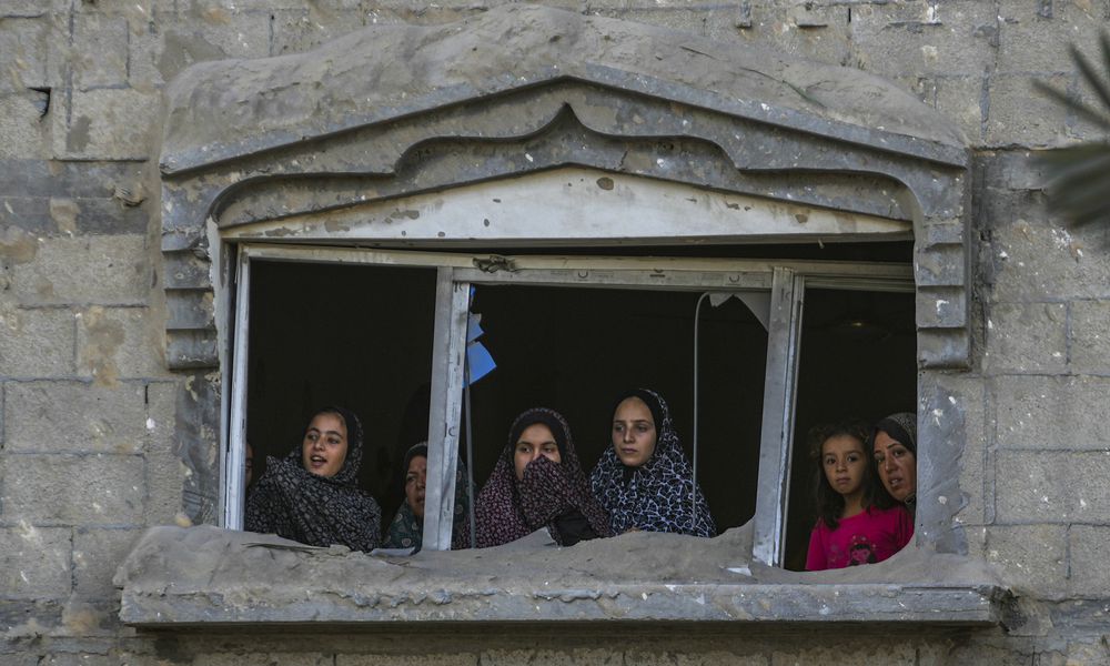 Palestinians look at the destruction after an Israeli airstrike on a crowded tent camp housing Palestinians displaced by the war in Muwasi, Gaza Strip, Tuesday, Sept. 10, 2024. An Israeli strike killed at least 40 people and wounded 60 others early Tuesday, Palestinian officials said. Israel said it targeted 