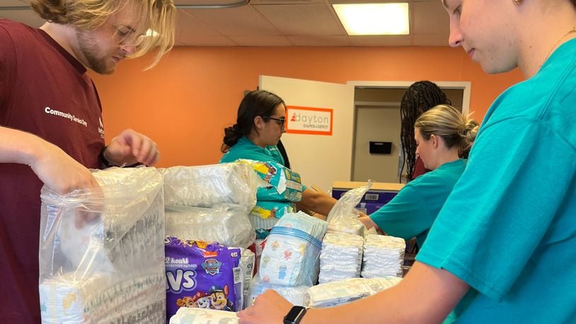 Students from Kettering College of Nursing help wrap and prepare diapers for Dayton Diaper Depot distribution.