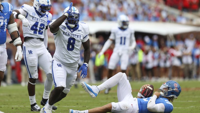 Kentucky defensive lineman Octavious Oxendine (8) reacts after sacking Mississippi quarterback Jaxson Dart (2) during the first half of an NCAA college football game against Mississippi Saturday, Sept. 28, 2024, in Oxford, Miss. (AP Photo/Randy J. Williams)