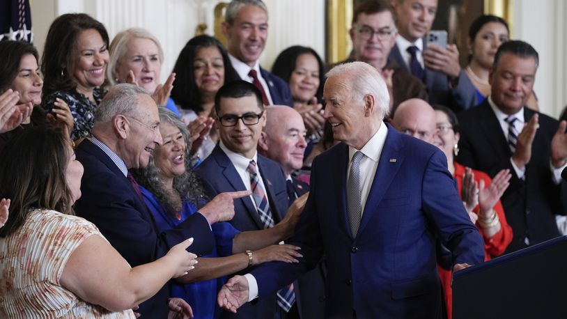 President Joe Biden turns to the others on the dais after speaking during an event marking the 12th anniversary of the Deferred Action for Childhood Arrivals program, in the East Room of the White House in Washington, Tuesday, June 18, 2024. (AP Photo/Susan Walsh)