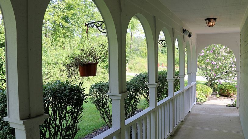 A wrap-around front porch leads to the formal front entry way, and a tree-lined neighboring park provides some added privacy. Contributed photos by Kathy Tyler