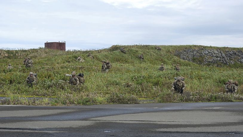 In this image released by the U.S. Army, U.S. Army soldiers assigned to 1st Battalion, 501st Parachute Infantry Regiment, 2nd Infantry Brigade Combat Team (Airborne), 11th Airborne Division, maneuver through the thick terrain of Shemya Island, Alaska, as part of a force projection operation to the remote island in the North Pacific Ocean, Sept. 13, 2024. (Spc. Brandon Vasquez/U.S. Army via AP)