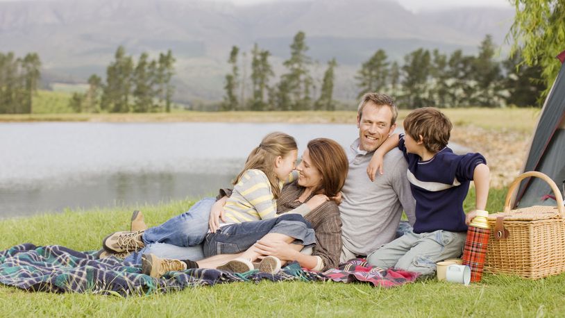 A family enjoys summer time next to a lake. PAUL BRADBURY/ISTOCK