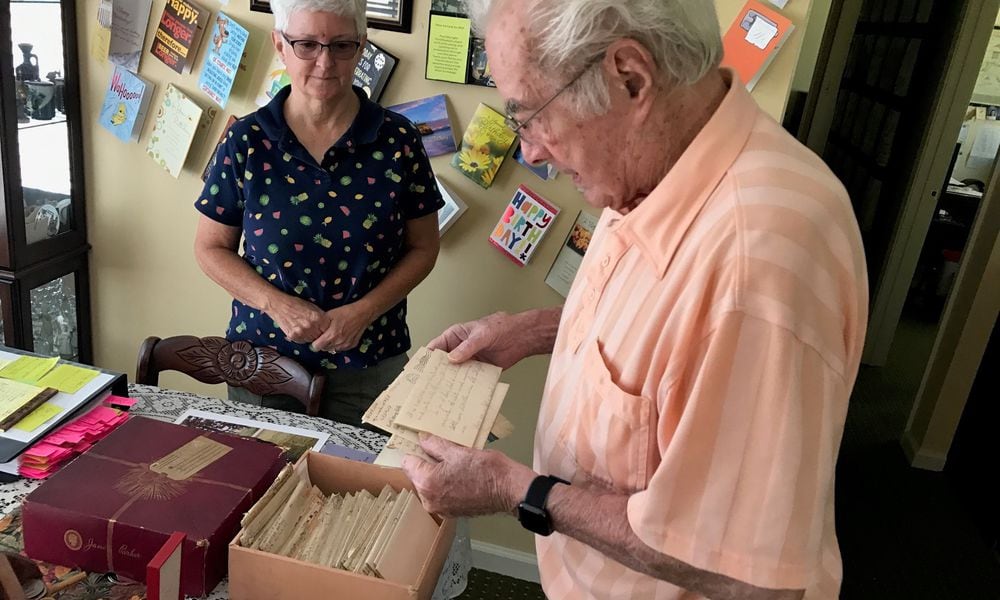 With daughter Beverly Rutan looking on, Walter Stitt looks at one of the 82 letters (the rest are in the hat box in front of him) he wrote during World War II to his mother who was living in West Virginia. Some of his letters were penned when he was in basic and advanced training at Camp Polk, Louisiana and the rest came as he served in Sherman tanks in France, Belgium and Germany. He was in some of the wars deadliest battles: the Battle of Normandy and the Battle of the Bulge. Twice his tank commanders and others alongside him in tanks were killed by German shells. He received two Purple Hearts; the National Order of the Legion of Merit, the highest honor of France; and the Order of Saint George Medallion, the top award given to members of the Army's mounted force (tanks, cavalry) by the United States Armor Association of the United States Army. Tom Archdeacon/CONTRIBUTED