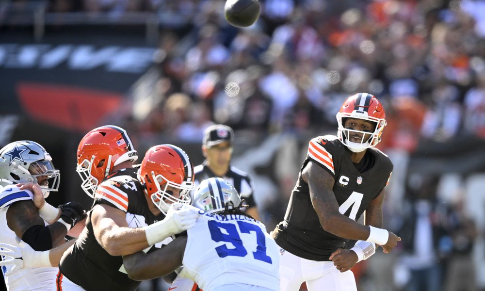 Cleveland Browns quarterback Deshaun Watson (4) throws a pass under pressure from Dallas Cowboys defensive tackle Osa Odighizuwa (97) in the first half of an NFL football game in Cleveland, Sunday, Sept. 8, 2024. (AP Photo/David Richard)