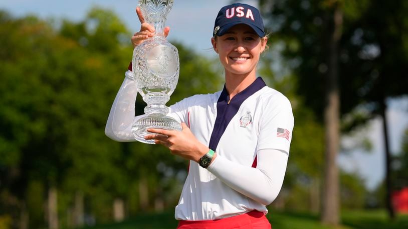 United States' Nelly Korda holds the winner's trophy after the United States defeated Europe in the Solheim Cup golf tournament at the Robert Trent Jones Golf Club, Sunday, Sept. 15, 2024, in Gainesville, Va. (AP Photo/Matt York)