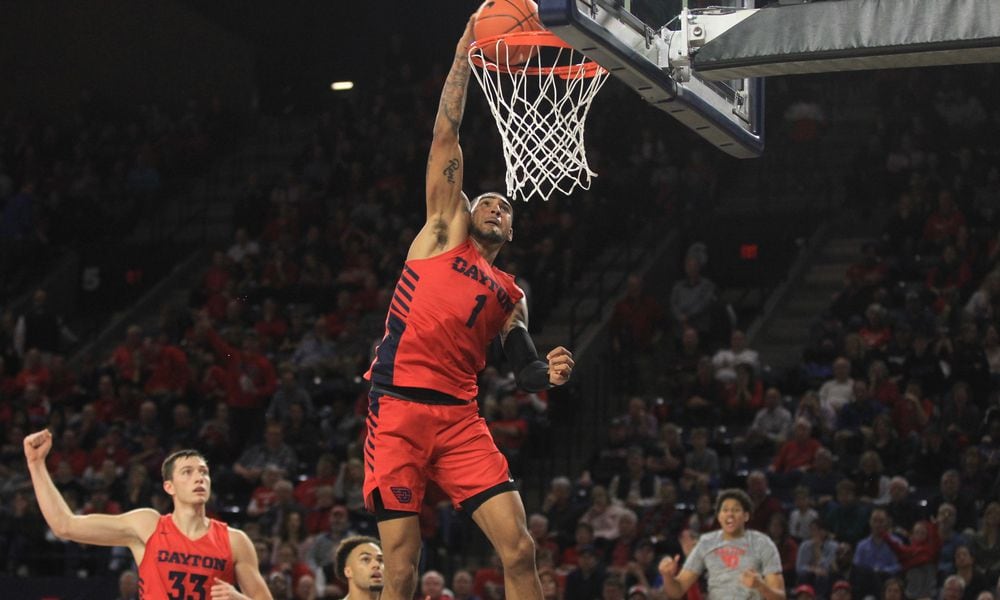 Dayton's Obi Toppin dunks against Richmond as Ryan Mikesell reacts in the background on Saturday, Jan. 25, 2020, at the Robins Center in Richmond, Va.