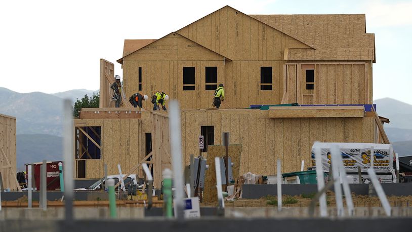 FILE - Workers toil on new homes in a housing development Tuesday, June 25, 2024, in Loveland, Colo. After showing signs of strengthening early this year, sales of new U.S. homes fell in April and May from a year earlier by 7.7% and 16.5%, respectively. (AP Photo/David Zalubowski, File)
