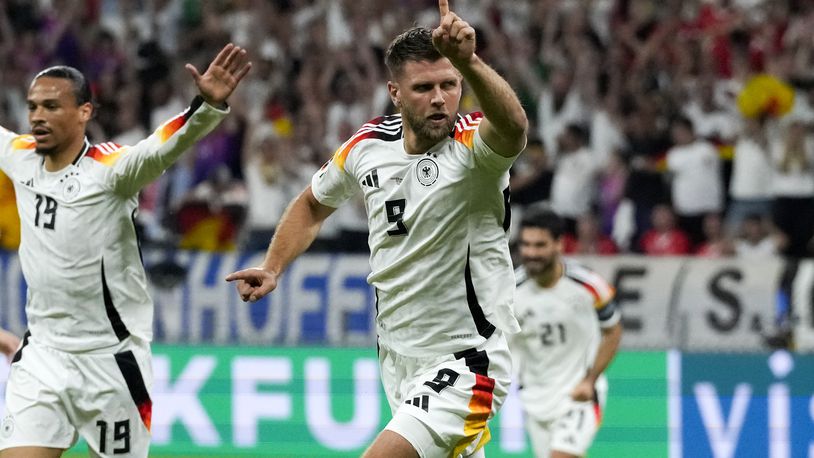APTOPIX Germany's Niclas Fuellkrug, center, celebrates scoring his side's first goal during a Group A match between Switzerland and Germany at the Euro 2024 soccer tournament in Frankfurt, Germany, Sunday, June 23, 2024. (AP Photo/Frank Augstein)
