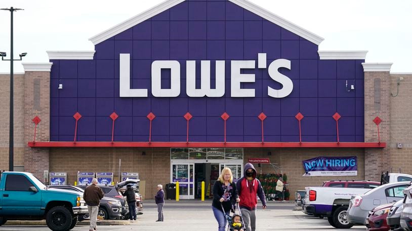 FILE - Shoppers walk in the lot of a Lowe's home improvement store in Philadelphia, Wednesday, Nov. 17, 2021. (AP Photo/Matt Rourke, File)