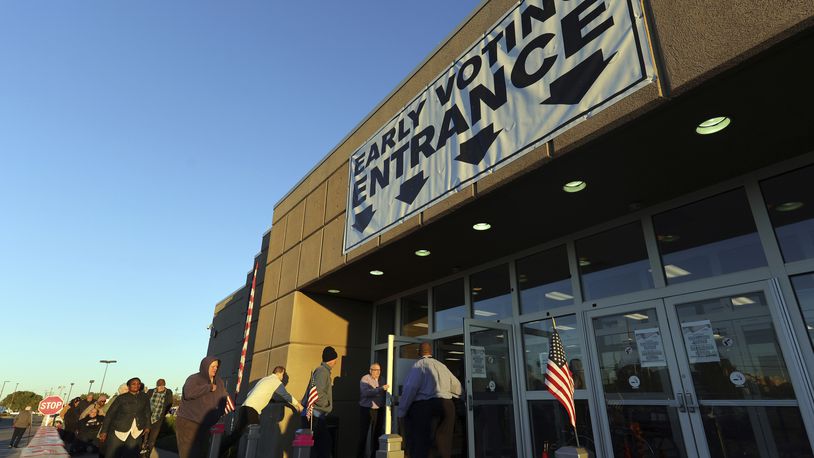 Voters enter the early voting center for the first day of in person early voting at the Franklin County Board of Elections in Columbus, Ohio, Tuesday, Oct. 8, 2024. (AP Photo/Paul Vernon)