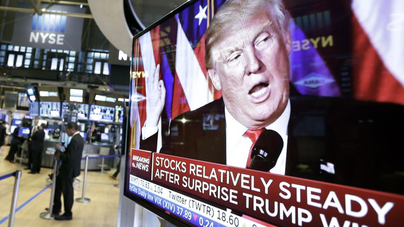 FILE - An image of President-elect Donald Trump appears on a television screen on the floor of the New York Stock Exchange, Nov. 9, 2016. (AP Photo/Richard Drew, File)