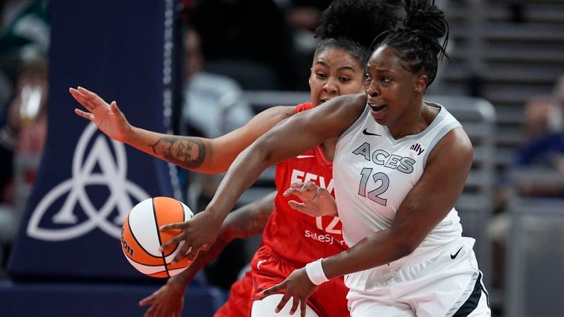 Las Vegas Aces' Chelsea Gray (12) makes a pass against Indiana Fever's Damiris Dantas during the first half of a WNBA basketball game, Wednesday, Sept. 11, 2024, in Indianapolis. (AP Photo/Darron Cummings)