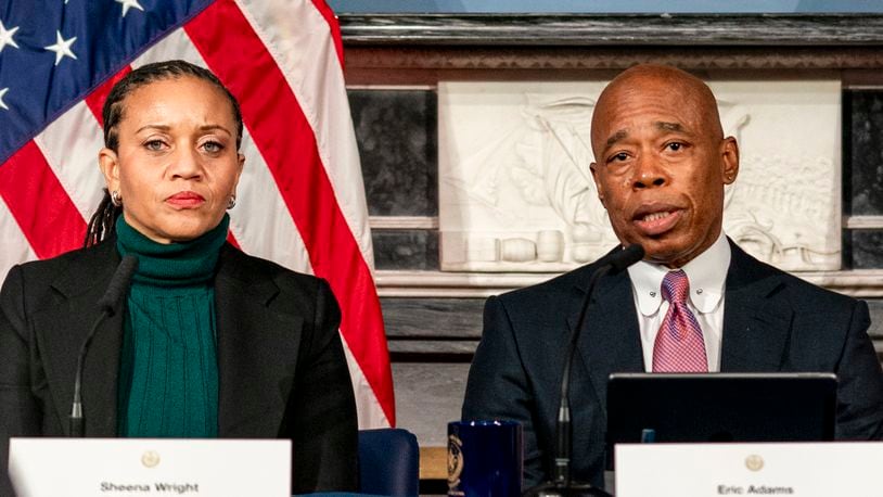 FILE - Mayor Eric Adams, right, is flanked by deputy mayor Sheena Wright, left, during a press conference at City Hall in New York, Dec. 12, 2023. (AP Photo/Peter K. Afriyie, File)