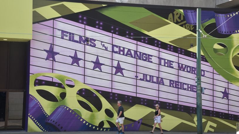 The Neon, an art house cinema in downtown Dayton, has a colorful new exterior. The mural pays tribute to Julia Reichert, a local Oscar-winning documentarian. CORNELIUS FROLIK / STAFF