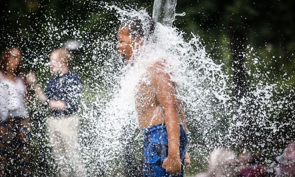 Kids and adults enjoyed the splash pad at Island MetroPark Tuesday June 18, 2024. This week the Dayton area is expecting near100 degree temperatures all week. JIM NOELKER/STAFF