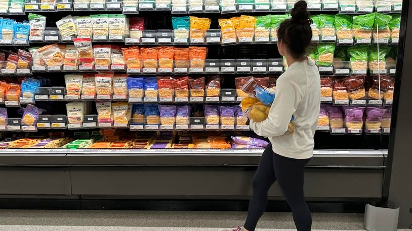 File - A shopper peruses cheese offerings at a Target store on Oct. 4, 2023, in Sheridan, Colo. Inflation is easing slightly, but grocery prices are still high. (AP Photo/David Zalubowski, File)