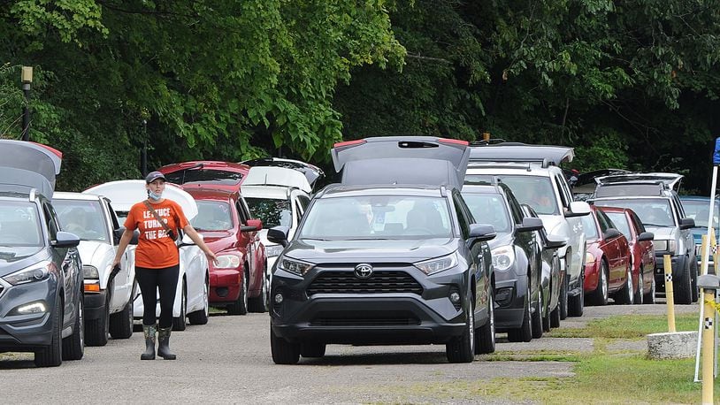 Hundreds of vehicles lined up on Tuesday Aug. 16, 2021, for the mass drive-through food distribution at the Dixie Twin Drive-In hosted by The Foodbank. MARSHALL GORBY\STAFF