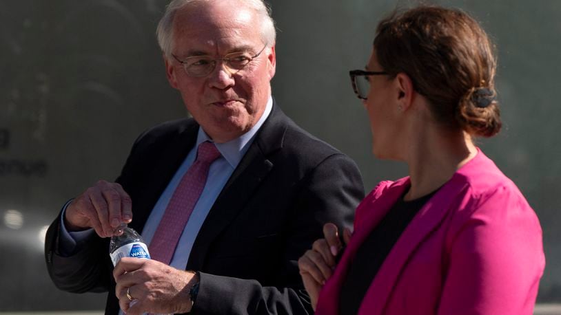 Kroger CEO Rodney McMullen holds a Fred Meyer brand water bottle as he talks with Erin Rolfes, Director of Corporate Communications & Media Relations at Kroger, right, while leaving federal court after testifying during a federal court hearing on Wednesday, Sept. 4, 2024, in Portland, Ore. Fred Meyer's parent company is Kroger. (AP Photo/Jenny Kane)