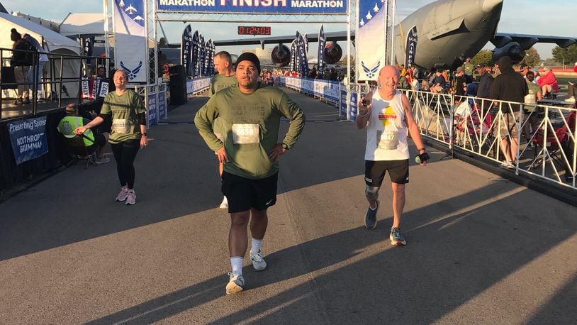 Mickey Lozan (right) finishing the 10 K race at last year’s Air Force Marathon. For the second year in a row he’d won the 80-and-up division of the race. Tom Archdeacon/CONTRIBUTED