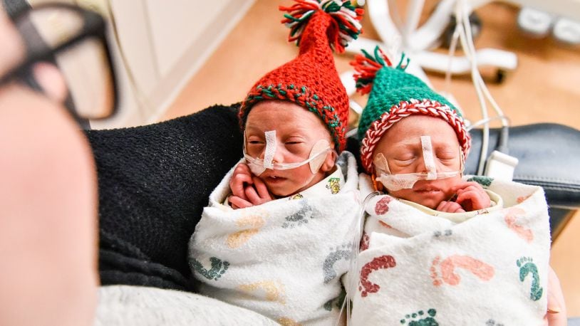 Elyssa Williams holds her sons Grayson Donald Smith, left, and Bradley Wayne Smith Thursday, Dec. 19 in The Berry Women’s Health Pavilion at Miami Valley Hospital in Dayton. The twins were born at 30 weeks to parents Elyssa Williams and Ryan Smith on Dec. 7 and have been in the NICU at the hospital. Grayson and Bradley both weighed 2 lbs,15oz. at birth. NICK GRAHAM/STAFF