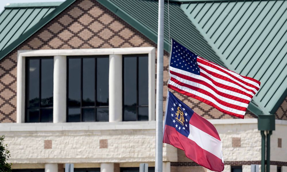 The American and state of Georgia flags fly half-staff after a shooting Wednesday at Apalachee High School, Thursday, Sept. 5, 2024, in Winder, Ga. (AP Photo/Mike Stewart)