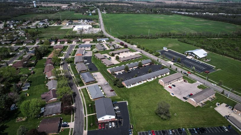 An aerial view of North Hyatt Street in Tipp City, looking northeast, shows the west side of the street heavily developed, but the east side untouched except for the Upper Room Worship Center. An attempt to have the land at the top right of the photo rezoned in advance of development was recently rejected by the city. JIM NOELKER/STAFF