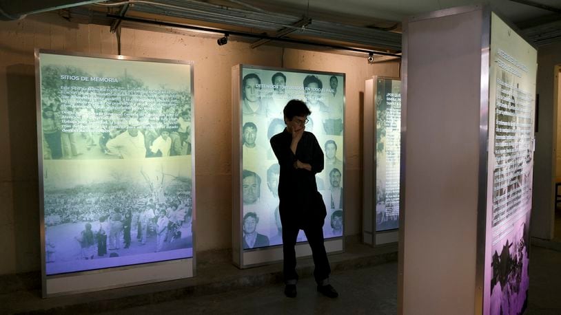 FILE - A visitor looks at an exhibit during the inauguration of a memorial to victims of Mexico's "dirty war" at the former Federal Security headquarters where student protesters were taken in 1971 following a violent crackdown in Mexico City, June 10, 2019. (AP Photo/Cristina Baussan, File)