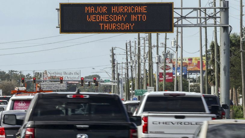 Highway signage announces the impending arrival of Hurricane Milton and the evacuations zones on Tuesday, Oct. 8, 2024, in Port Richey, Fla. (AP Photo/Mike Carlson)