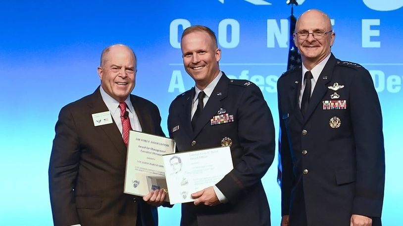 Then-Col. Jason Bartolomei, center, receives the Air Force Materiels Command Management and Gen. Larry D. Welch Award-Executive Division during the Air Force Association Air, Space and Cyber Conference in National Harbor, Md., in September 2019. U.S. Air Force photo by Andy Morataya.