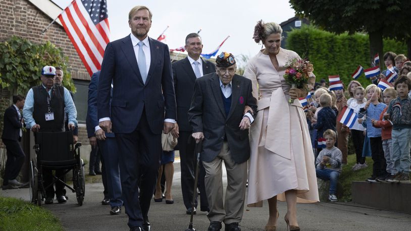 World War II veteran Kenneth Thayer is escorted by Dutch King Willem-Alexander and Queen Maxima during a ceremony marking the 80th anniversary of the liberation of the south of the Netherlands in Mesch, Thursday, Sept. 12, 2024. (AP Photo/Peter Dejong)