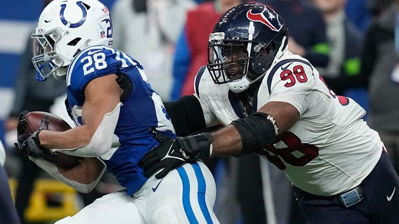 FILE- Houston Texans defensive tackle Sheldon Rankins (98) tackles Indianapolis Colts running back Jonathan Taylor (28) of an NFL football game Saturday, Jan. 6, 2024, in Indianapolis. The Cincinnati Bengals have bolstered their defense by agreeing on contracts with defensive tackle Sheldon Rankins and safety Vonn Bell, two people familiar with the terms told The Associated Press on Thursday, March 14, 2024. (AP Photo/Darron Cummings, File)