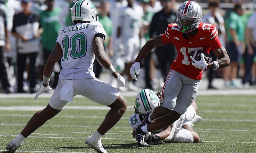 Ohio State receiver Carnell Tate, right, is tackled by Marshall linebacker Jaden Yates during the second half of an NCAA college football game, Saturday, Sept. 21, 2024, in Columbus, Ohio. (AP Photo/Jay LaPrete)