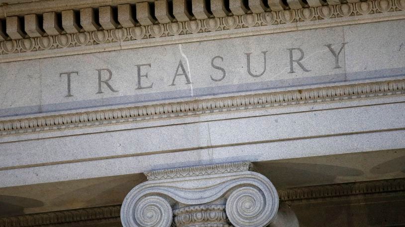 FILE- This photo shows the U.S. Treasury Department building at dusk in Washington, June 6, 2019. (AP Photo/Patrick Semansky, File)