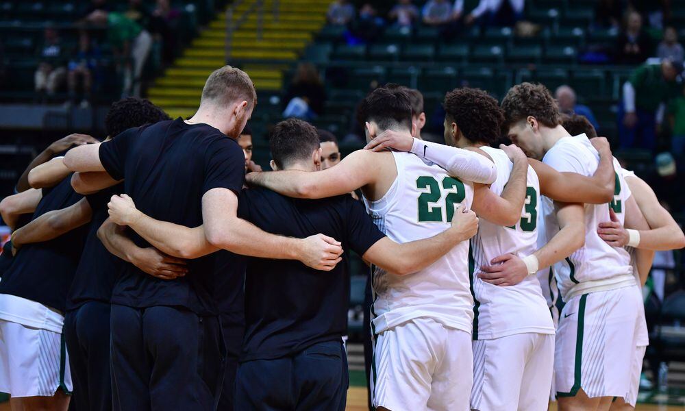 Members of the Wright State men's basketball team huddle before a game earlier this season. Wright State Athletics photo