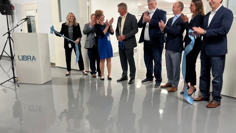 The ribbon is cut: LIbra Industries and Dayton leaders celebrate the opening of a new $1.8 million clean room to support semiconductor fabrication work in Dayton Thursday. THOMAS GNAU/STAFF