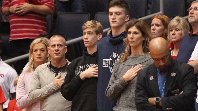 Lukas Frazier (third from left) watches a game between Dayton and Purdue Fort Wayne on Nov. 16, 2018, at UD Arena with his parents Kriss (far left) and Chad. Jackson Ames, a 2020 recruit from West Clermont who committed to Miami, stands to Frazier’s right. David Jablonski/Staff