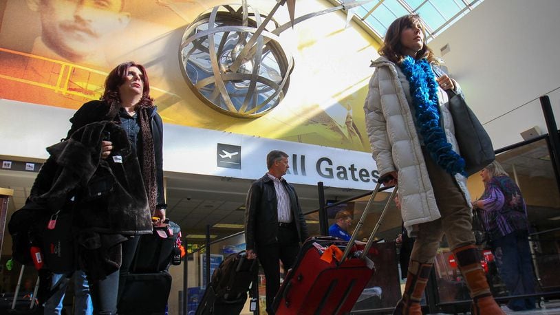 Travelers move through the lobby of the Dayton International Airport. Prepare to get to the airport early and ride on full or nearly full flights this Thanksgiving holiday season.The number of people traveling between Nov. 22 and Dec. 3 is expected to increase 1.5 percent this year to about 31,000 travelers per day, according to airline trade group Airlines For America. And flights are expected to be at least 85 percent full.And if you wait much longer to book any Christmas holiday flights, be ready to pay more. Last year, travelers who booked Christmas holiday flights in early December paid 28 percent more than those who booked flights earlier. And the price jumped 52 percent for flights booked after Dec. 10.
JIM WITMER / STAFF