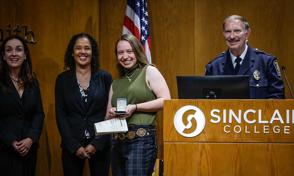 Dayton Daily News reporter London Bishop received special recognition for reporting on and participating in the Sinclair College Criminal Justice Training Academy on Wednesday evening June 12, 2024, at the graduation ceremony held at Sinclair College. JIM NOELKER/STAFF
