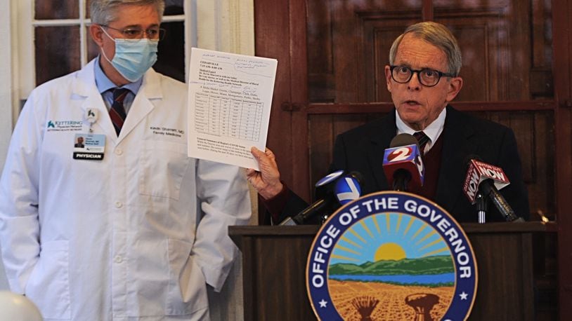 Gov. Mike DeWine asked Ohioans to reduce contact with people outside their homes as coronavirus cases and hospitalizations continue to rise in the state. STAFF/MARSHALL GORBY
