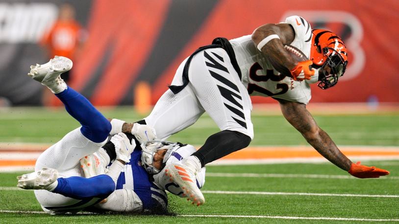 Cincinnati Bengals running back Trayveon Williams (32) is tackled by Indianapolis Colts safety Rodney Thomas II, left, during the first half of a preseason NFL football game, Thursday, Aug. 22, 2024, in Cincinnati. (AP Photo/Jeff Dean)