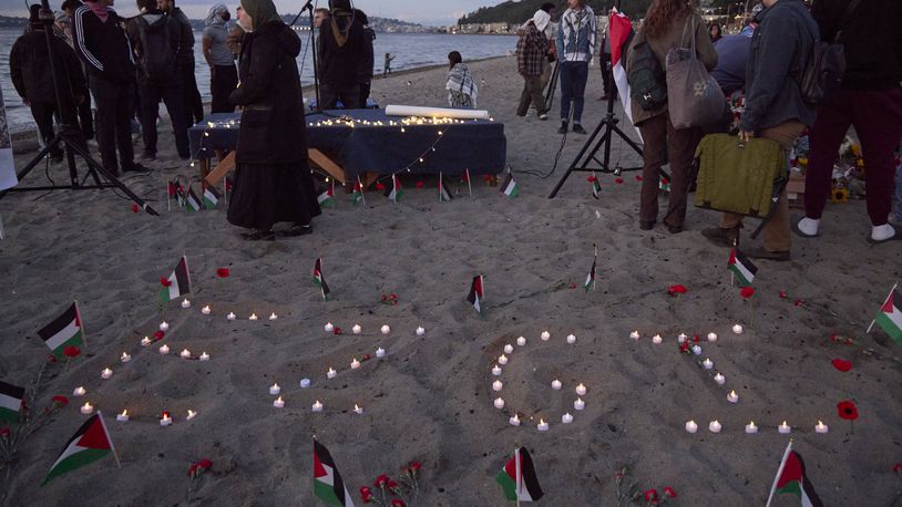 Ezgi is spelled in candles on the sand during a vigil on Alki Beach for Aysenur Ezgi Eygi, a 26-year-old activist from Seattle, who was killed recently in the West Bank, Wednesday, Sept. 11, 2024, in Seattle. (AP Photo/John Froschauer)